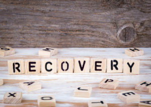 RECOVERY spelled out on Scrabble blocks
